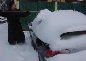Cleaning snow off my car after our first snow storm in November.