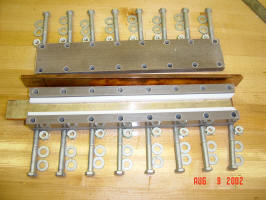 Here the channel through which the slug will travel along the bottom rail, between the Teflon spacers can be seen.