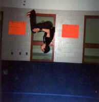 Doing a standing back flip on the University gymnastics room.